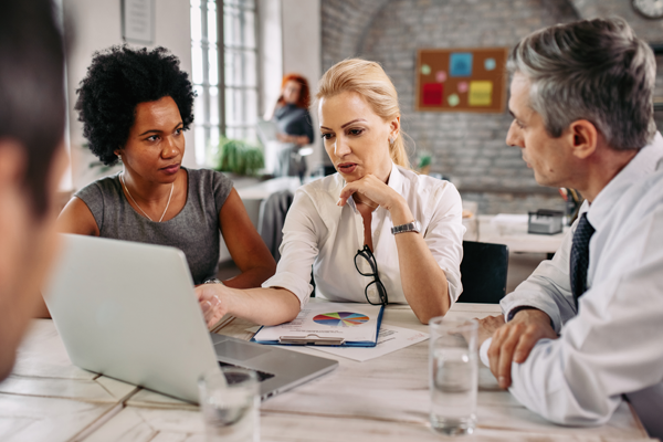 Medical Professionals having a meeting around a laptop
